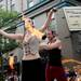 Actors with the Ring of Steel Action Theatre and Stunt Troupe spin fire as they ride a float through the 23rd Annual Ann Arbor Jaycees Fourth of July Parade on Thursday, July 4, 2013 on South State Street in downtown Ann Arbor. Melanie Maxwell | AnnArbor.com
